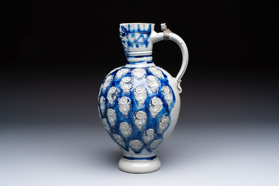 A Westerwald stoneware jug with a lion's head and moulded floral design, Germany, 17th C.