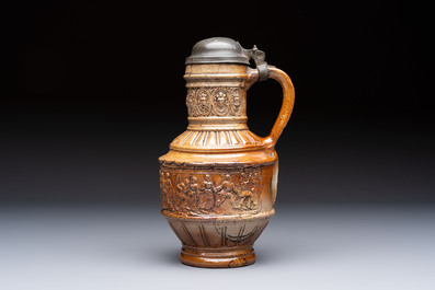 A Raeren stoneware 'Peasants Dance' jug with a mounted pewter lid, dated 1587