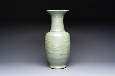 A Chinese celadon-glazed vase with relief lotus scroll design, 18th C.