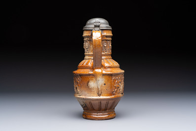 A Raeren stoneware 'Peasants Dance' jug with a mounted pewter lid, dated 1587