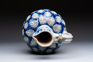 A Westerwald stoneware jug with a lion's head and moulded floral design, Germany, 17th C.