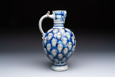 A Westerwald stoneware jug with a lion's head and moulded floral design, Germany, 17th C.