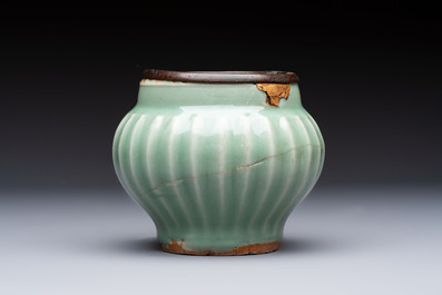 A Chinese Longquan celadon 'Lotus' jar with bronze mount, Song