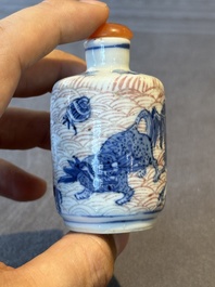 Two Chinese blue, white and copper-red 'Mythical Animals' snuff bottles, Qianlong mark and of the period
