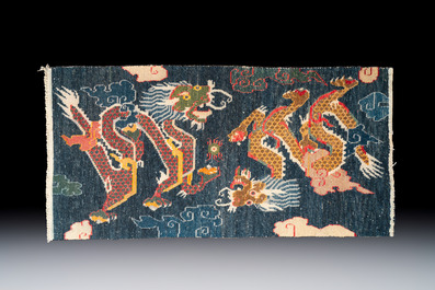 A Tibetan woollen &lsquo;Dragons Chasing the Flaming Pearl&rsquo; carpet, 19th C.