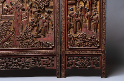A Chinese carved gilt-lacquered wooden three-panel folding screen with a narrative design, 19/20th C.