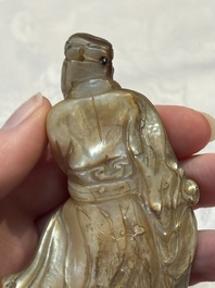 A Chinese carved mother-of-pearl figure of an official on wooden stand, 18/19th C.