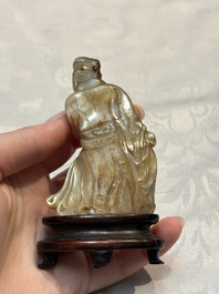 A Chinese carved mother-of-pearl figure of an official on wooden stand, 18/19th C.