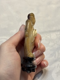 A Chinese carved mother-of-pearl figure of an official on wooden stand, 18/19th C.
