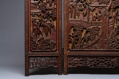 A Chinese carved gilt-lacquered wooden three-panel folding screen with a narrative design, 19/20th C.