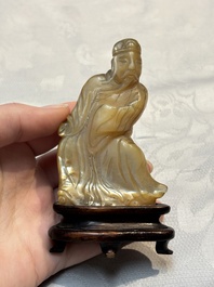 A Chinese carved mother-of-pearl figure of an official on wooden stand, 18/19th C.