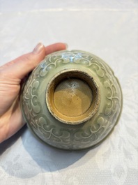 A Chinese carved Yaozhou celadon-glazed bowl with floral design, Jin