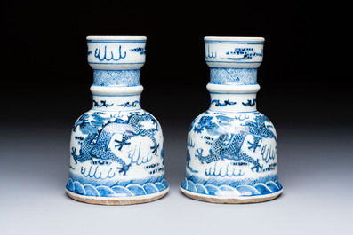 A pair of Chinese blue and white 'Dragons Chasing the Flaming Pearl&rsquo; candlesticks, 19th C.
