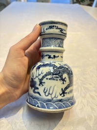 A pair of Chinese blue and white 'Dragons Chasing the Flaming Pearl&rsquo; candlesticks, 19th C.