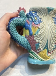 A Chinese famille rose ewer in the form of a dragon and two carps with wooden cover and stand, 19th C.