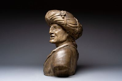 A large patinated terracotta bust of a smiling Oriental man, 18/19th C.