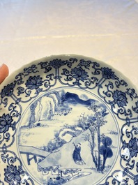 A very fine Chinese blue and white plate with a scholar in a landscape, Kangxi mark and of the period