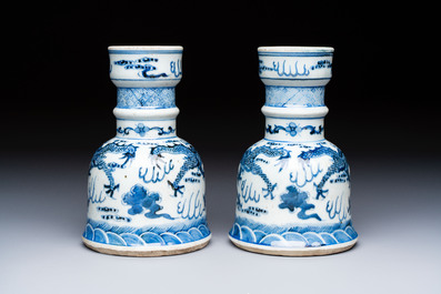 A pair of Chinese blue and white 'Dragons Chasing the Flaming Pearl&rsquo; candlesticks, 19th C.