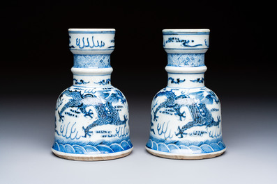 A pair of Chinese blue and white 'Dragons Chasing the Flaming Pearl&rsquo; candlesticks, 19th C.