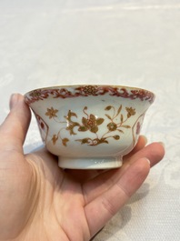 A pair of Chinese famille rose gilt-decorated covered cups and saucers and an openworked cup, Qianlong