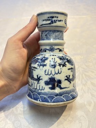 A pair of Chinese blue and white 'Dragons Chasing the Flaming Pearl&rsquo; candlesticks, 19th C.