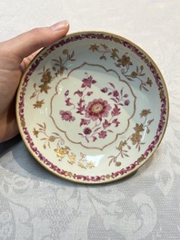 A pair of Chinese famille rose gilt-decorated covered cups and saucers and an openworked cup, Qianlong