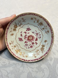 A pair of Chinese famille rose gilt-decorated covered cups and saucers and an openworked cup, Qianlong