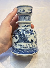 A pair of Chinese blue and white 'Dragons Chasing the Flaming Pearl&rsquo; candlesticks, 19th C.