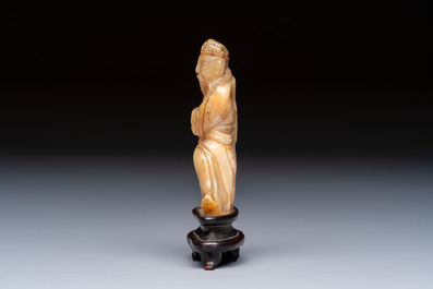 A Chinese carved mother-of-pearl figure of an official on wooden stand, 18/19th C.