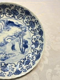 A very fine Chinese blue and white plate with a scholar in a landscape, Kangxi mark and of the period
