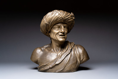 A large patinated terracotta bust of a smiling Oriental man, 18/19th C.