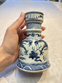 A pair of Chinese blue and white 'Dragons Chasing the Flaming Pearl&rsquo; candlesticks, 19th C.