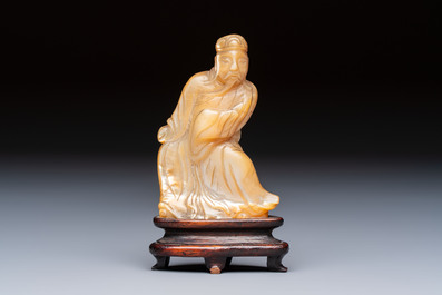A Chinese carved mother-of-pearl figure of an official on wooden stand, 18/19th C.