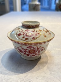 A pair of Chinese famille rose gilt-decorated covered cups and saucers and an openworked cup, Qianlong