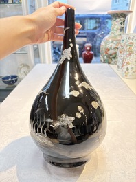 A Chinese black-glazed reverse-decorated bottle vase, 20th C.