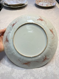 A pair of Chinese iron-red and gilt-decorated 'Elegant Beauties in a Garden' dishes, Kangxi