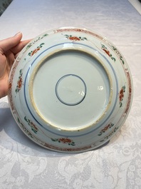 A pair of Chinese famille verte 'Ladies in a Garden' plates, Kangxi