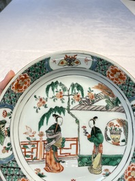 A pair of Chinese famille verte 'Ladies in a Garden' plates, Kangxi