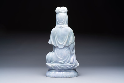 An exceptional and large Chinese carved pale lavender jadeite Guanyin on a wooden stand, Republic