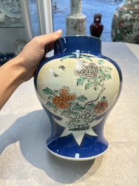 Two Chinese famille verte blue-ground vases and covers, 19th C.