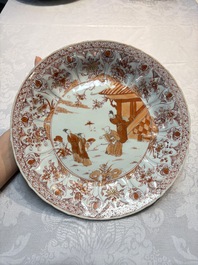 A Chinese iron-red and gilt-decorated dish with a garden scene, Kangxi