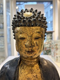 A large Chinese gilt-lacquered bronze Buddha, 17th C.