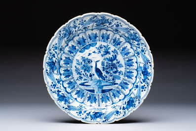 A pair of blue and white Dutch Delft 'Cranes' plates and a dish, 18th C.