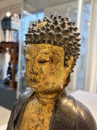 A large Chinese gilt-lacquered bronze Buddha, 17th C.