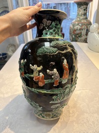An unusual Chinese famille noire vase with relief design, Kangxi mark, 19th C.