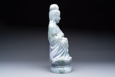 An exceptional and large Chinese carved pale lavender jadeite Guanyin on a wooden stand, Republic