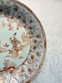 A pair of Chinese iron-red and gilt-decorated 'Elegant Beauties in a Garden' dishes, Kangxi
