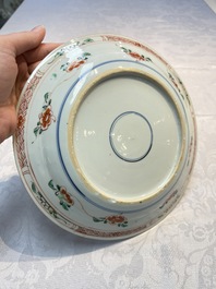 A pair of Chinese famille verte 'Ladies in a Garden' plates, Kangxi