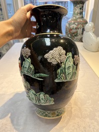 An unusual Chinese famille noire vase with relief design, Kangxi mark, 19th C.