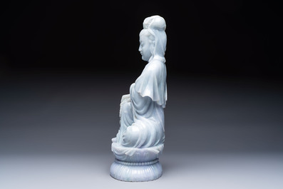 An exceptional and large Chinese carved pale lavender jadeite Guanyin on a wooden stand, Republic